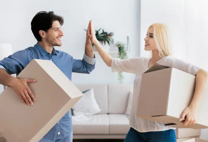 Couple high-five with boxes